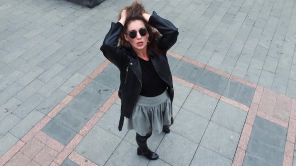 Top view, One young girl with dark hair dance on the street