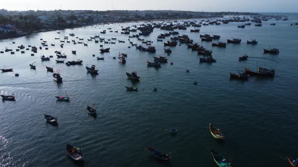 Aerial view of mui ne fishing harbor Vietnam Asia, catamaran fishing net traditional boat, drone rev alt