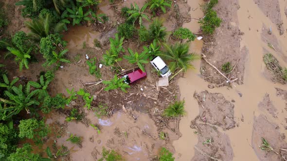 Top down view two cars is wash down by debris and mud alt