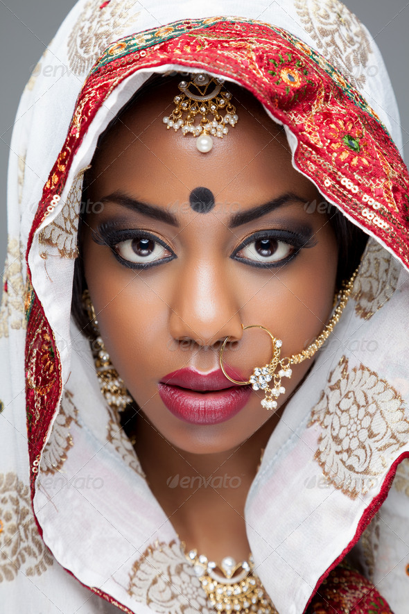 Young Indian woman in traditional clothing with bridal makeup and jewelry - Stock Photo - Images