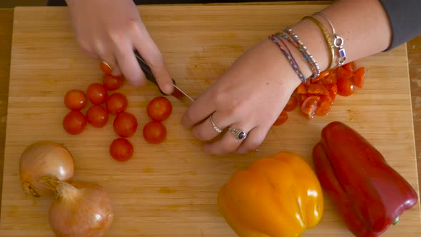 woman's hands cutting cherry tomatoes - cooking pasta alt