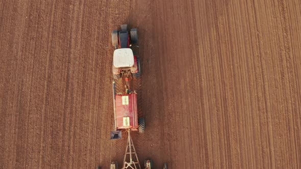 Aerial View to Tractor Plowing Field