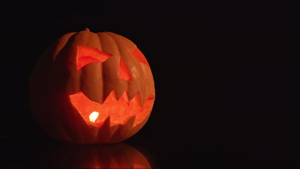 Dark Night a Lantern in the Shape of a Pumpkin on Halloween. alt
