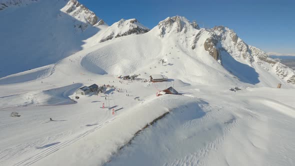 FPV Drone Sunny Ski Resort Panorama Active People Enjoying Winter Extreme Sport Outdoor Activity alt