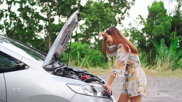 Young woman was having a bad car breakdown and felt frustrated while traveling