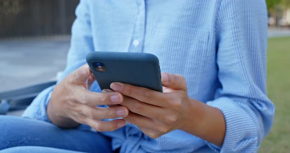 Woman use of mobile phone at outdoor alt