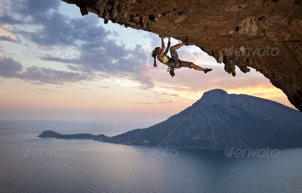 Young female rock climber at sunset - Stock Photo - Images