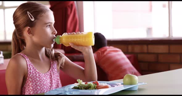 Portrait of schoolgirl having breakfast alt