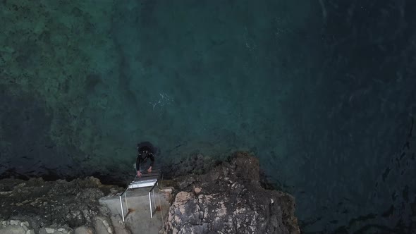 Man getting out of deep blue sea alt