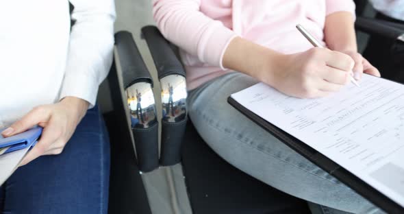 Group of People Filling Out Documents for Obtaining American Visa  Movie alt