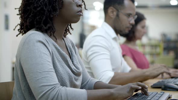 Focused African American Woman Typing on Keyboard alt
