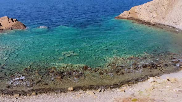Clear and Shallow Sea Water of the Cove Surrounded by Stone and Rocky Coastline