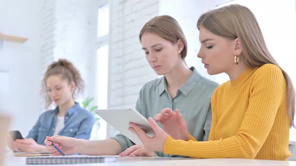 Ambitious Creative Team Discussing and Working on Tablet alt