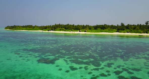 Daytime drone travel shot of a white paradise beach and blue ocean background alt