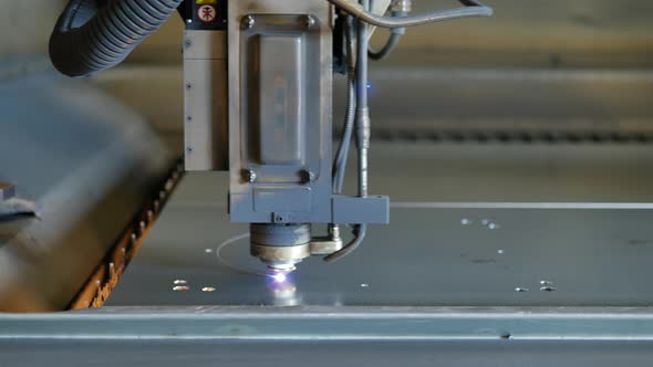 Laser cut machine while cutting the sheet metal with sparks and high precision alt