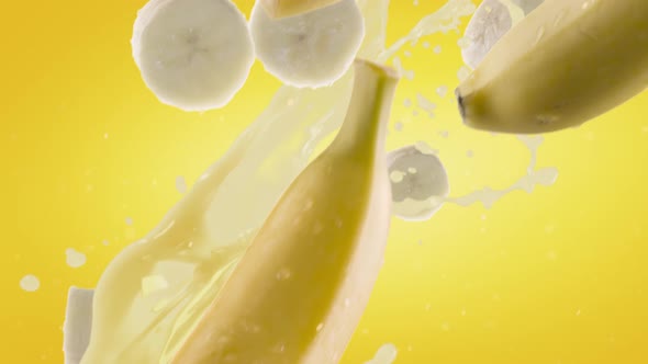 Banana with Slices Falling on Yellow Background alt