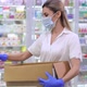 Tired Caucasian Female Pharmacist Putting Bottles with Pills on Shelf in Drugstore Taking Off - VideoHive Item for Sale