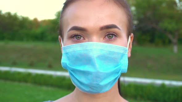 Portrait of a Young Woman Wearing Protective Mask on Street