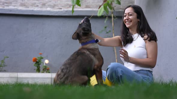 Woman Playing With Dog in the Garden alt