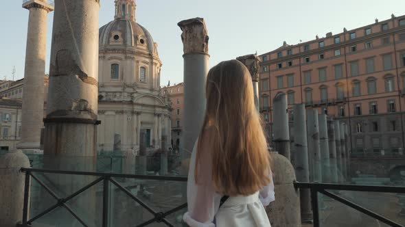 Portrait of Young Tourist Woman Exploring European Town at Sunrise