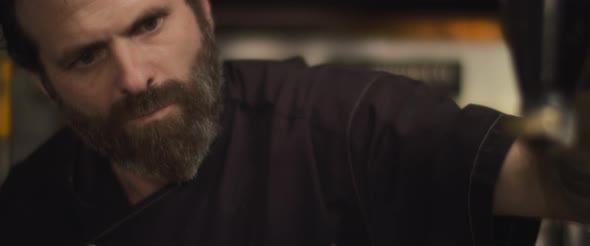 Close up of Italian chef spreading balsamic sauce over a pizza. Slow motion. alt