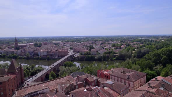 Saint James cathedral, Old Bridge and Ingres Museum approaching in Montauban France, Aerial flyover alt