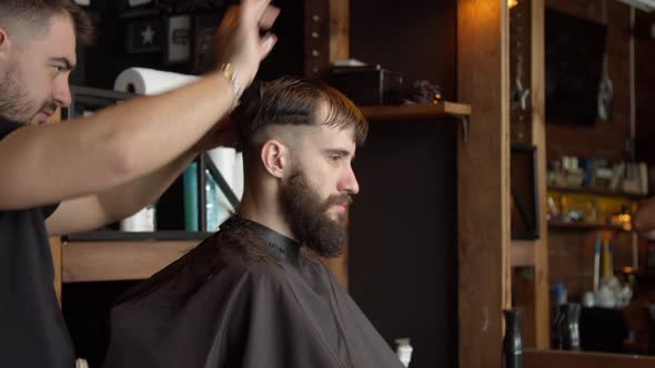 Barber Cutting Hair of Male Client