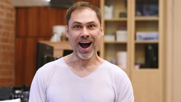 Amazed Surprised Positive Middle Age Man in Office alt