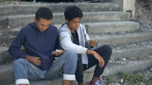 Needy Young Men Counting Coins Sitting Stairs, Dysfunctional Family Children alt
