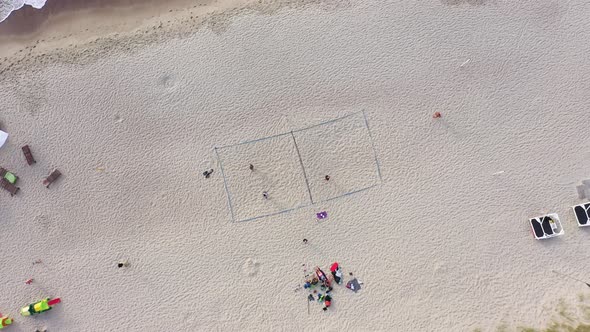 AERIAL: Rotating Shot of Volleyball Court on a Sea Sandy Beach