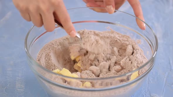 Hand mixing chocolate bun dough for baking.	