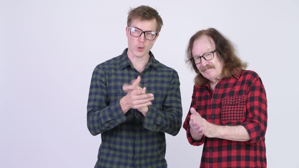 Happy Senior Hipster Man and Young Hipster Man Clapping Hands Together alt