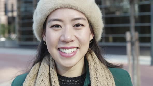 Portrait of Smiling Young Asian Woman in City Street alt