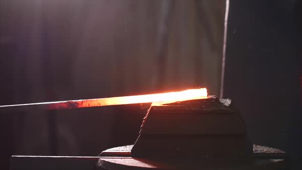 Blacksmith Using Hammer Machine for Shaping Hot Metal Blank in Forge Workshop