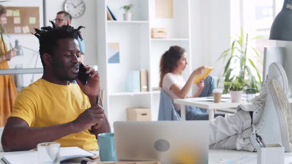 Businessman Talking on Phone during Working Day alt