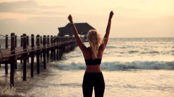 Woman Stretching And Warming-Up Before Running. Girl Limbering-Up And Stretching Legs And Hands. alt
