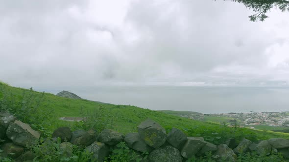 Drone taking off from top of Pico do Facho, Portugal. Aerial forward alt