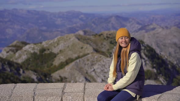 A Young Woman Traveler Visits the View Point on the Top of the Lovcen Mountain alt