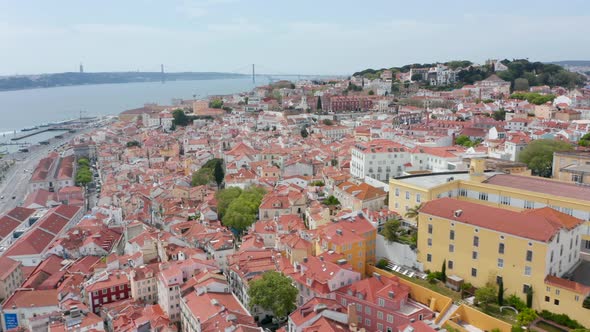 Flying Over Rooftops of Colorful Houses in Dense Urban City Center of Lisbon Portugal alt