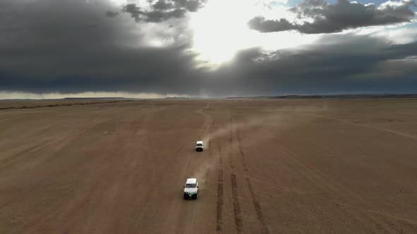 Vehicles Driving on Wide Dirt Roads in Central Asian Steppes alt