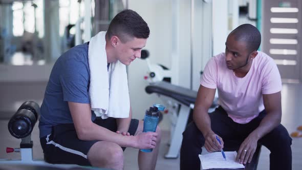 African American Guy Talking To a Caucasian Guy The Coach Gives the Installation Ward People alt