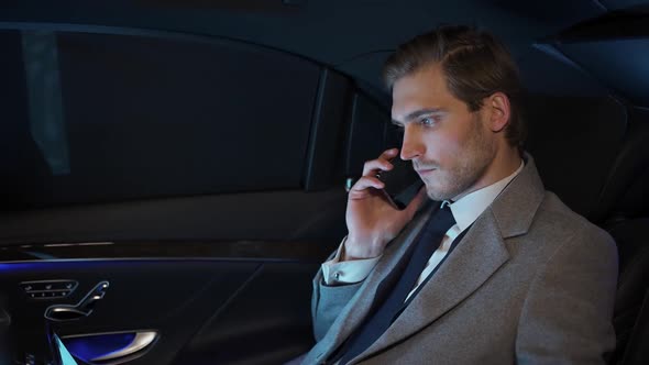Businessman is Sitting in a Moving Car Talking on a Mobile Phone and Using Laptop Man Top Manager in alt