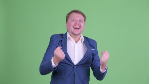 Happy Overweight Bearded Businessman Getting Good News alt