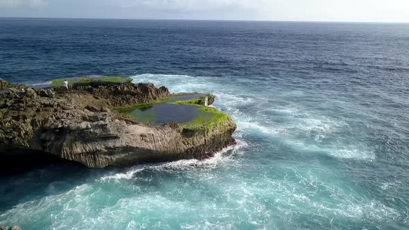 Fantastic aerial view flight slowly circle drone shotBig ocean waves crashing on the rocks of Devil alt