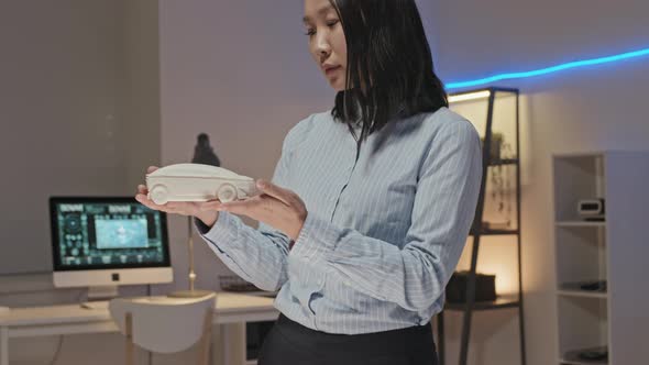 Slowmo of Female Engineer Inspecting D Printed Prototype alt