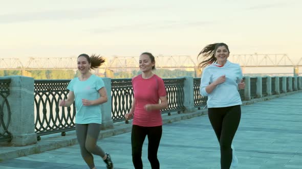 Slow Motion Shot of Three Girls Friends Morning Run alt