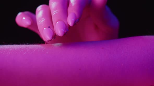 Hand Skin in Pink Neon Light Female Human Body Part and Ultraviolet Touching Arm Surface Macro alt