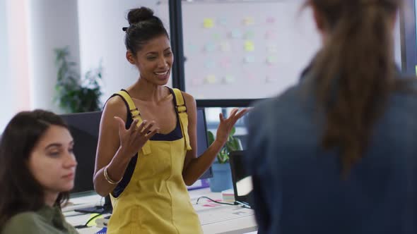 Diverse group of female business colleagues discussing alt