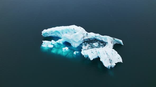 Breathtaking Drone Shot of an Iceberg in the Vast Blue Ocean alt