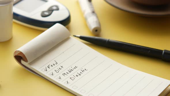 Check Mark on a Check Box on a Paper with Glucose Meter on Table alt